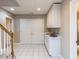 Basement features white cabinetry and sink area, with tiled floors and access to a bathroom at 204 Highlands Lake Dr. Dr, Cary, NC 27518