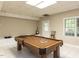 Finished basement recreation room with pool table, neutral walls, and a door to the exterior at 204 Highlands Lake Dr. Dr, Cary, NC 27518