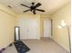 Spacious basement features a ceiling fan, built-in storage, and neutral paint and carpet at 204 Highlands Lake Dr. Dr, Cary, NC 27518