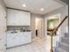 Basement with white cabinetry, sink, tiled flooring, and access to stairs and billiard room at 204 Highlands Lake Dr. Dr, Cary, NC 27518