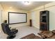 Finished basement area with projector screen, theater chairs and neutral paint and carpet at 204 Highlands Lake Dr. Dr, Cary, NC 27518