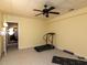 Basement featuring neutral paint and carpet, ceiling fan, and an area ready for exercise equipment at 204 Highlands Lake Dr. Dr, Cary, NC 27518