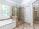 Bathroom features a walk-in shower, soaking tub and tiled floor at 204 Highlands Lake Dr. Dr, Cary, NC 27518