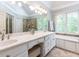 Bright bathroom with double sink vanity, garden tub, and a walk-in shower at 204 Highlands Lake Dr. Dr, Cary, NC 27518