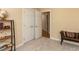 Neutral bedroom offers ample closet space, carpeted floors, and a cozy bench with decorative pillow at 204 Highlands Lake Dr. Dr, Cary, NC 27518
