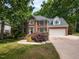 Stately two-story brick home with black shutters, two-car garage and nicely landscaped front yard at 204 Highlands Lake Dr. Dr, Cary, NC 27518