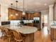 Kitchen with granite countertops, stainless appliances, hardwood floors and breakfast bar seating at 204 Highlands Lake Dr. Dr, Cary, NC 27518
