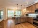 Spacious kitchen featuring an eat-in area, stainless appliances, and beautiful hardwood floors at 204 Highlands Lake Dr. Dr, Cary, NC 27518