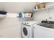 Bright laundry room featuring a modern, front-load washer and dryer with ample shelving for storage at 204 Highlands Lake Dr. Dr, Cary, NC 27518