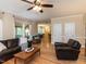 Open living area featuring hardwood floors, a brick fireplace, and seamless flow into the dining area at 204 Highlands Lake Dr. Dr, Cary, NC 27518