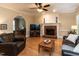 Inviting living room features a fireplace, hardwood floors, and arched doorway to the piano room at 204 Highlands Lake Dr. Dr, Cary, NC 27518