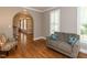 Living room with hardwood floors, chair, and grey couch at 204 Highlands Lake Dr. Dr, Cary, NC 27518