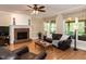 Spacious living room featuring a brick fireplace, hardwood floors, and an adjacent screened porch at 204 Highlands Lake Dr. Dr, Cary, NC 27518
