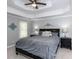 Main bedroom with tray ceiling, ceiling fan, and stylish decor at 204 Highlands Lake Dr. Dr, Cary, NC 27518