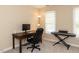 Functional office features a desk, chair, computer, keyboard and natural light, ideal for productivity at 204 Highlands Lake Dr. Dr, Cary, NC 27518