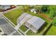 Aerial view of property with a metal roof, surrounding greenery, and convenient parking area at 212 Orange St, Oxford, NC 27565