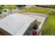 Aerial view showcases the building's metal roof, concrete parking, and outdoor patio at 212 Orange St, Oxford, NC 27565