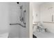 Accessible bathroom features safety grab bars and a handheld shower head for enhanced safety and convenience at 212 Orange St, Oxford, NC 27565