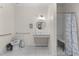 Well-lit bathroom has safety grab bars and a vanity with ample counter space and storage underneath at 212 Orange St, Oxford, NC 27565