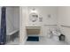 Accessible bathroom with a roll-under sink, grab bars, and tiled floors at 212 Orange St, Oxford, NC 27565