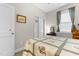 Comfortable bedroom featuring a charming floral quilt, window with curtains, and classic décor at 212 Orange St, Oxford, NC 27565