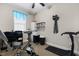 Bright exercise room with ceiling fan, treadmill, stationary bike and ample space at 212 Orange St, Oxford, NC 27565