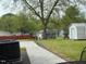 Exterior view of the outdoor space, picnic tables, and some storage buildings at 212 Orange St, Oxford, NC 27565