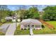 Exterior of a cozy home with a metal roof, landscaped yard, and inviting front porch at 212 Orange St, Oxford, NC 27565