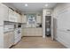 Well-lit kitchen with white appliances, light cabinets, and wood floors at 212 Orange St, Oxford, NC 27565