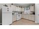 Inviting kitchen with white appliances, light cabinets, and ample counter space at 212 Orange St, Oxford, NC 27565