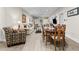 An open living space with lots of natural light, hardwood floors, a dining area, and comfortable seating at 212 Orange St, Oxford, NC 27565