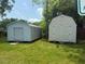 Two storage sheds on lawn; the one in the foreground is white with a double door at 212 Orange St, Oxford, NC 27565
