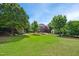 Expansive backyard with lush greenery and a welcoming patio area at 220 Lakecroft Pl, Fuquay Varina, NC 27526