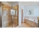 Large primary bathroom with tiled shower, soaking tub, and granite counters with double sinks at 220 Lakecroft Pl, Fuquay Varina, NC 27526