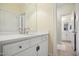 Well-lit bathroom with a white vanity, quartz countertop, and mirror, plus a second bathroom is shown at 220 Lakecroft Pl, Fuquay Varina, NC 27526