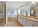 Bathroom features granite countertops, double sinks, a separate tub and glass enclosed shower with tile surround at 220 Lakecroft Pl, Fuquay Varina, NC 27526