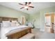 Spacious bedroom with a ceiling fan, ensuite bathroom, and plenty of natural light for a comfortable living space at 220 Lakecroft Pl, Fuquay Varina, NC 27526
