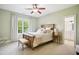 Comfortable bedroom with neutral carpet, wooden furniture, natural light and ensuite bathroom for added convenience at 220 Lakecroft Pl, Fuquay Varina, NC 27526