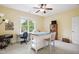 Versatile bonus room with natural light, sewing table, and ample space for creative projects and storage at 220 Lakecroft Pl, Fuquay Varina, NC 27526