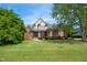 Charming brick home featuring a landscaped front yard, inviting entrance and beautiful curb appeal at 220 Lakecroft Pl, Fuquay Varina, NC 27526