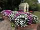 Charming garden with colorful flowers and a yellow garden shed adds character to this home at 220 Lakecroft Pl, Fuquay Varina, NC 27526