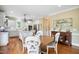 Spacious open concept kitchen and dining area with white cabinetry, modern stainless steel appliances and fixtures at 220 Lakecroft Pl, Fuquay Varina, NC 27526