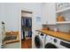 Well-organized laundry room with wood countertop, washer and dryer, plus walk-in closet for ample storage at 220 Lakecroft Pl, Fuquay Varina, NC 27526