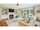 Inviting living room featuring a cozy fireplace, built-in shelving, and bright natural light at 220 Lakecroft Pl, Fuquay Varina, NC 27526