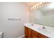 Bathroom featuring double sinks, a vanity, and bright lighting at 2253 Violet Bluff Ct, Raleigh, NC 27610