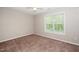 Simple bedroom design with carpet floors and window with bright natural light at 2253 Violet Bluff Ct, Raleigh, NC 27610