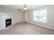 Bright living room with fireplace and large window bringing in natural light at 2253 Violet Bluff Ct, Raleigh, NC 27610