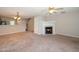 Cozy living room featuring a fireplace, neutral tones, and ceiling fan at 2253 Violet Bluff Ct, Raleigh, NC 27610