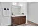 Bathroom features a double sink vanity, large mirror, and wood grain vinyl flooring at 234 Robert Howe Dr, Fuquay Varina, NC 27526