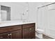 Bathroom features a single sink vanity, large mirror, shower, and vinyl flooring at 234 Robert Howe Dr, Fuquay Varina, NC 27526
